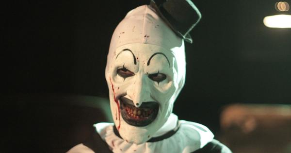 David Howard Thornton as Art the Clown with blood dripping down his mask and a small top hat on.